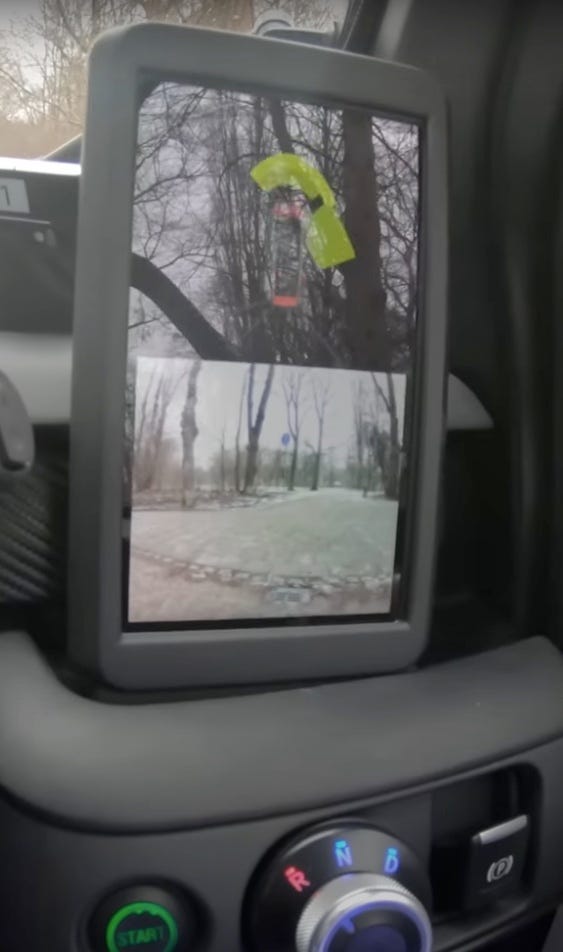 Dash-mounted monitor displaying backup camera feeds.