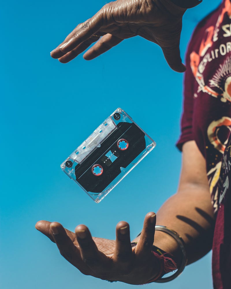 Person playing with a cassette tape