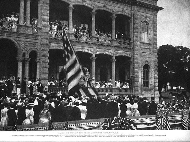 Historical image of the American flag being raised over Iolani Palace